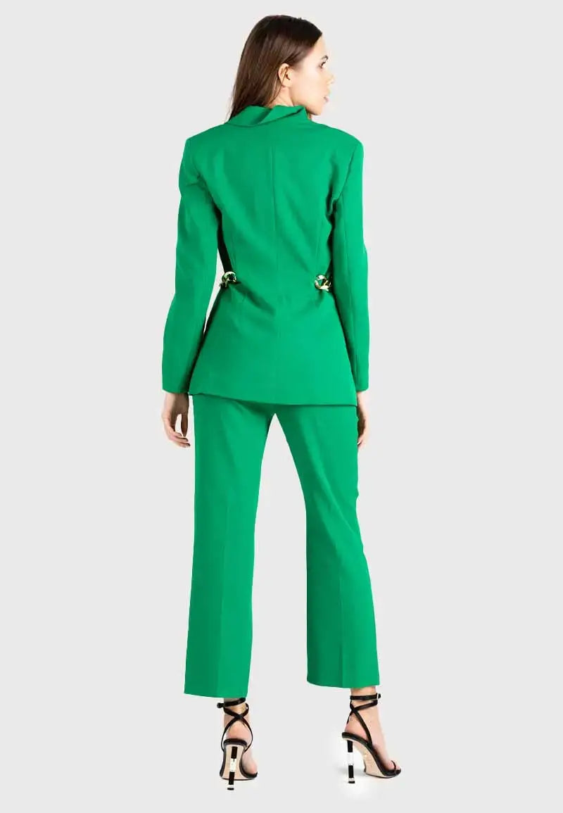 Women's suit consisting of a blazer, pants and gold chains on the sides