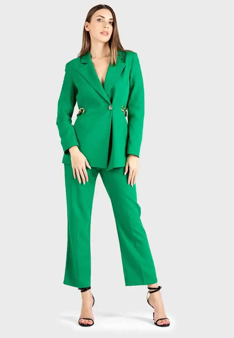 Women's suit consisting of a blazer, pants and gold chains on the sides