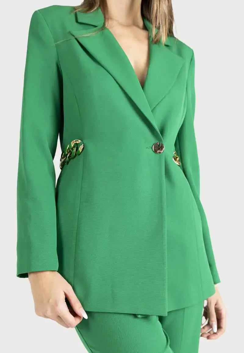 Women's suit consisting of a blazer, pants and gold chains on the sides