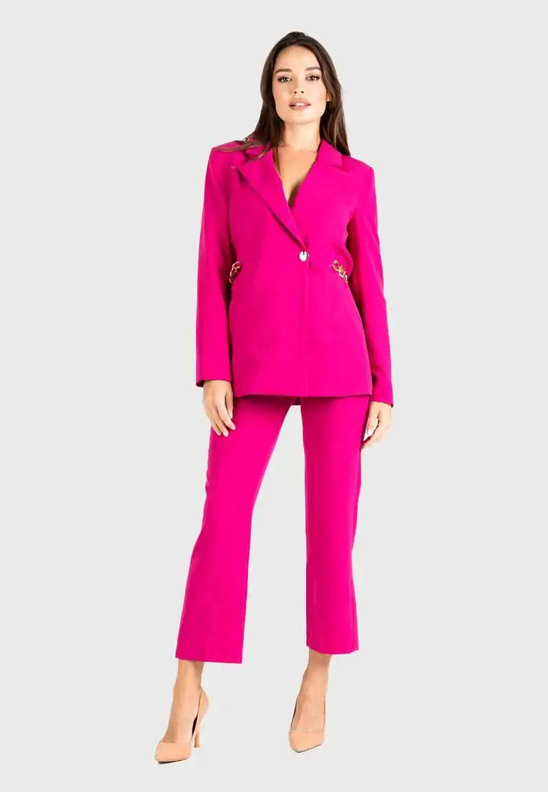 Women's suit consisting of a blazer, pants and gold chains on the sides
