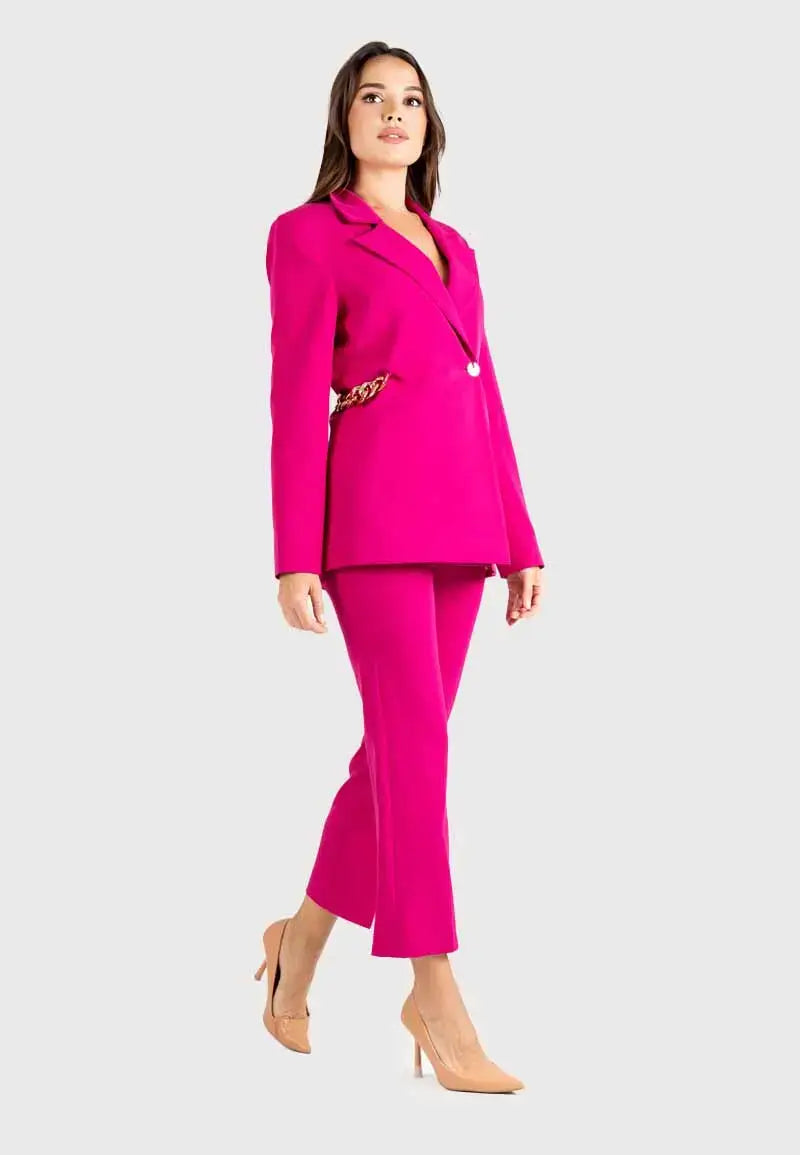Women's suit consisting of a blazer, pants and gold chains on the sides
