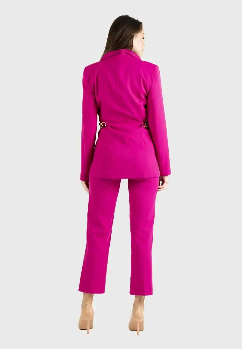 Women's suit consisting of a blazer, pants and gold chains on the sides