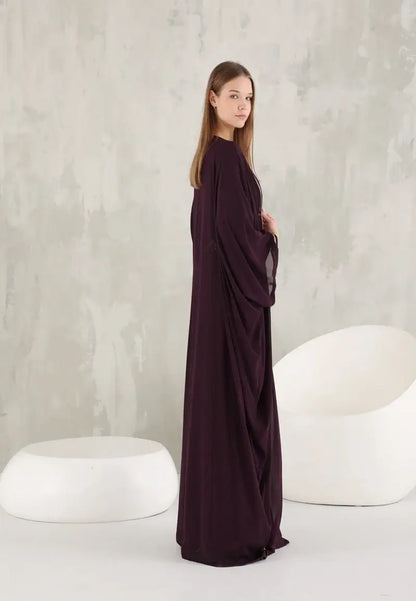 An ornate Moroccan Caftan with gold details and colourful stones