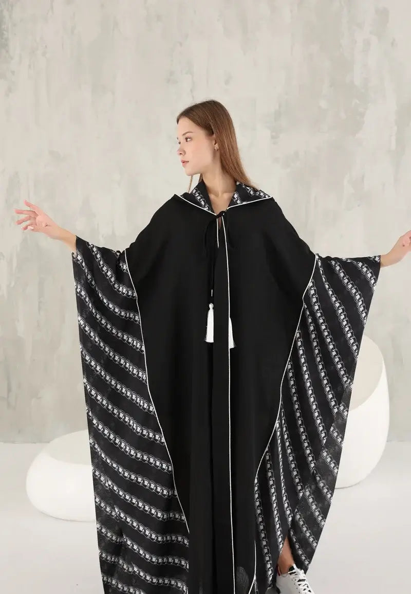Black women's wide abaya with white threads and a hat