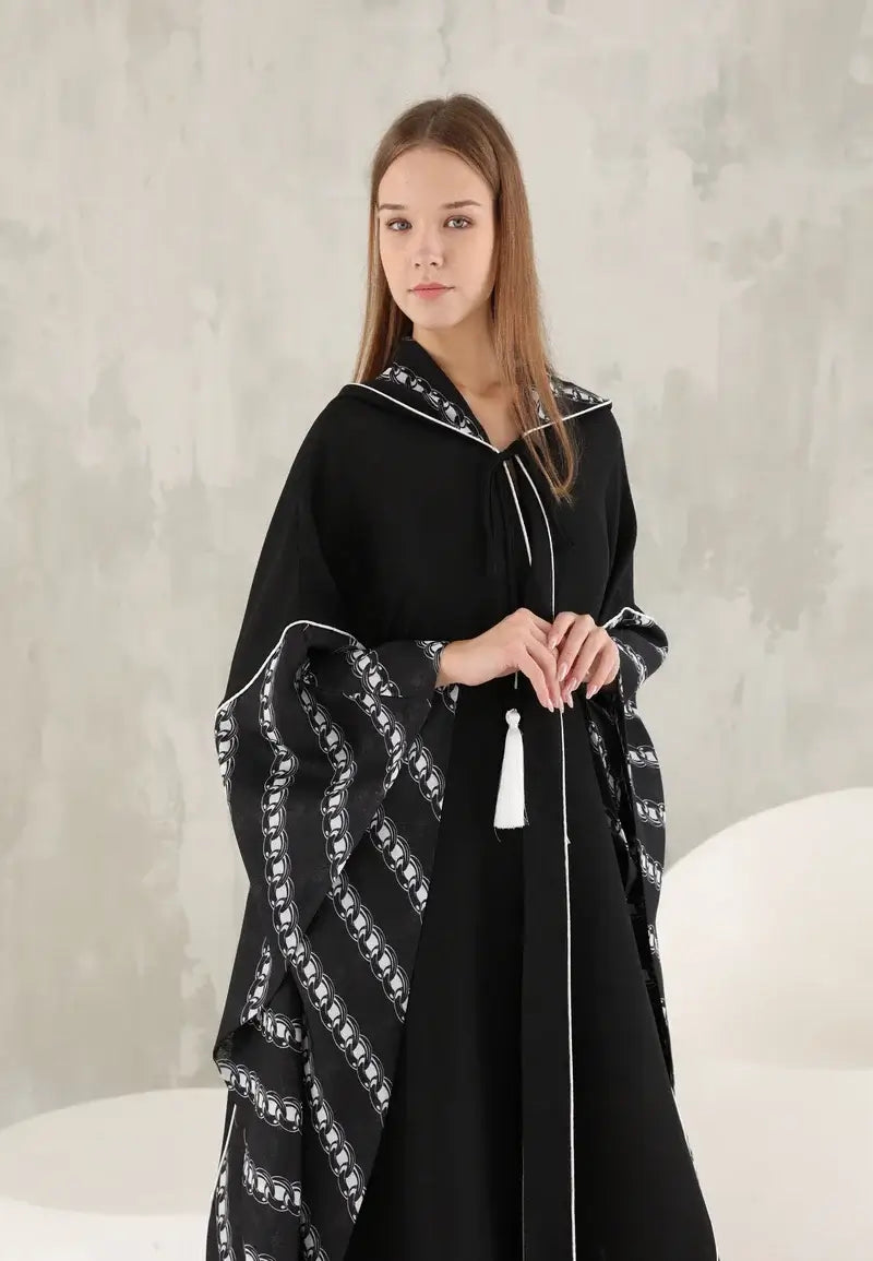 Black women's wide abaya with white threads and a hat