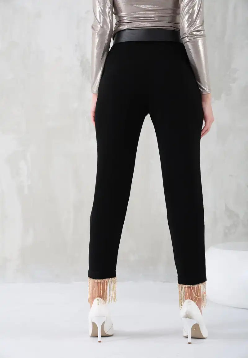 Black women's pants with gold chains at the bottom