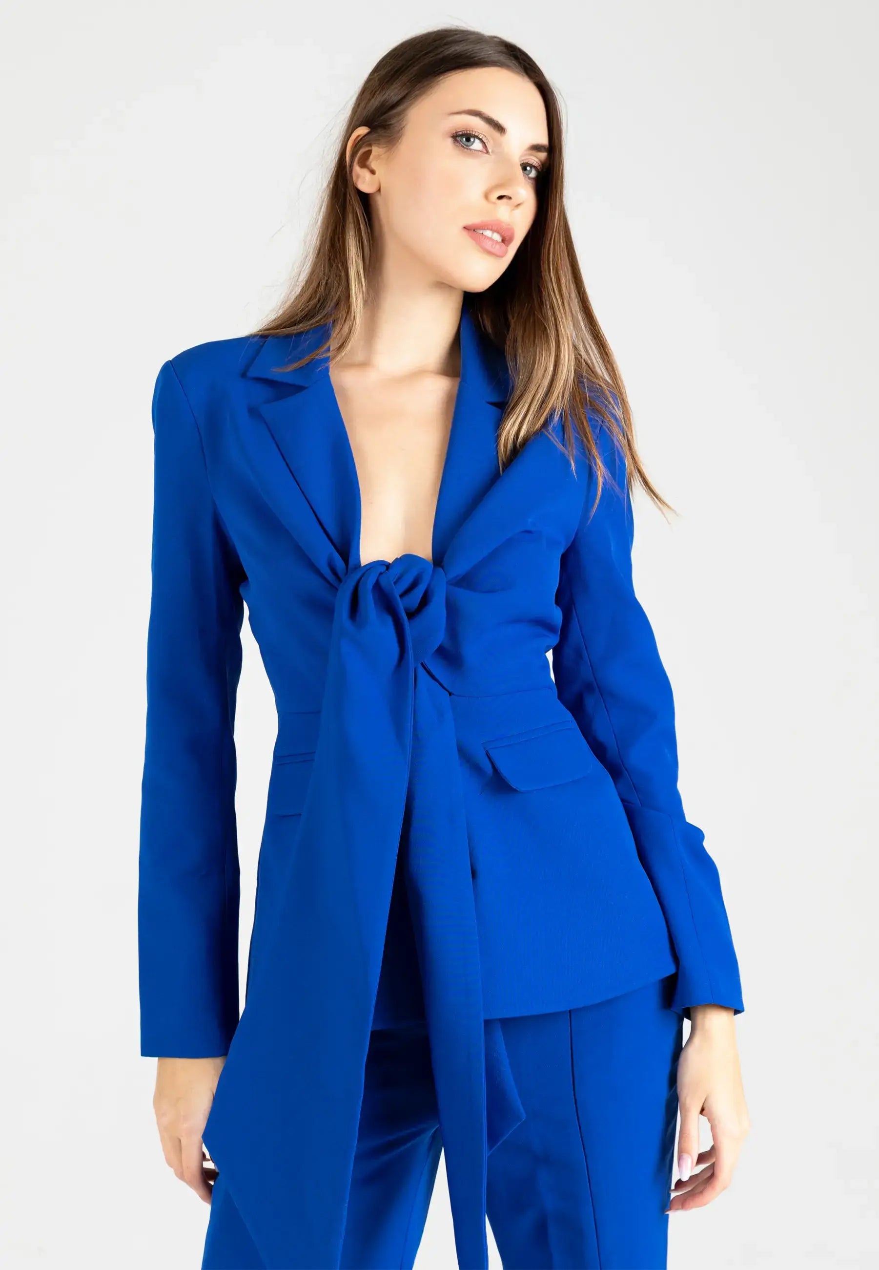 Women's suit consisting of a jacket with a knot and open pants from the bottom