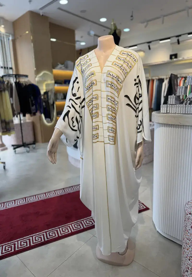 Luxurious black and white abaya embroidered with golden letters